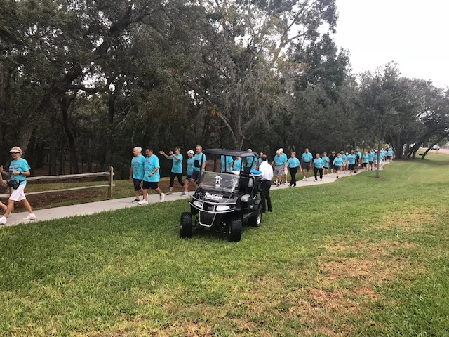 Senior Helpers handing out water to the walkers at the Annual Timber Pines Walk
