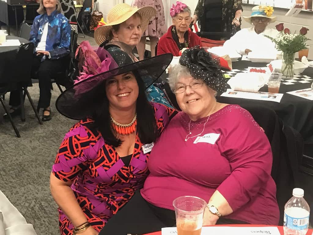 Owner, Nancy Galloway showing off her Derby hat with one of our great clients!